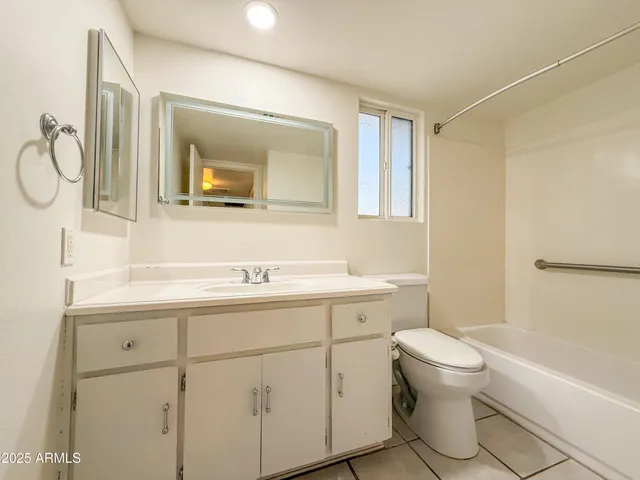 a bathroom with a toilet sink shower and mirror
