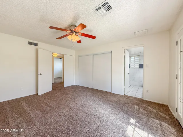 a view of a livingroom with a chandelier fan