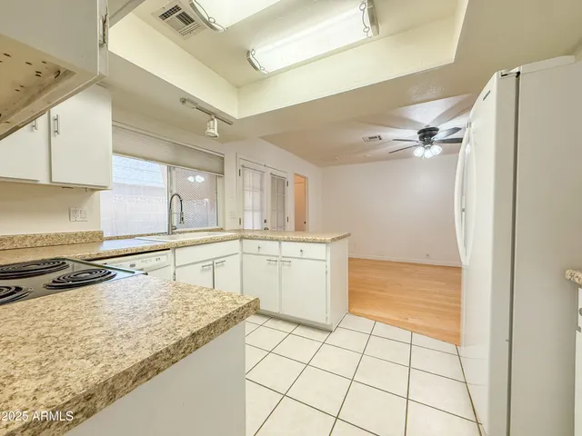 a kitchen with a stove a refrigerator and a sink