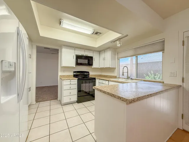 a kitchen with a stove a sink and a refrigerator