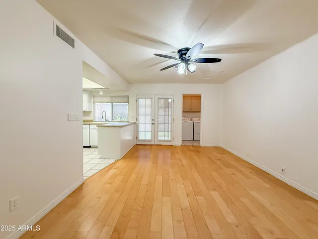 a view of a kitchen with wooden floor and a kitchen space