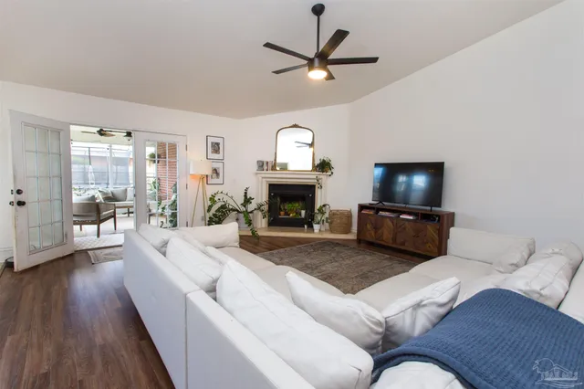 a living room with furniture a flat screen tv and a fireplace