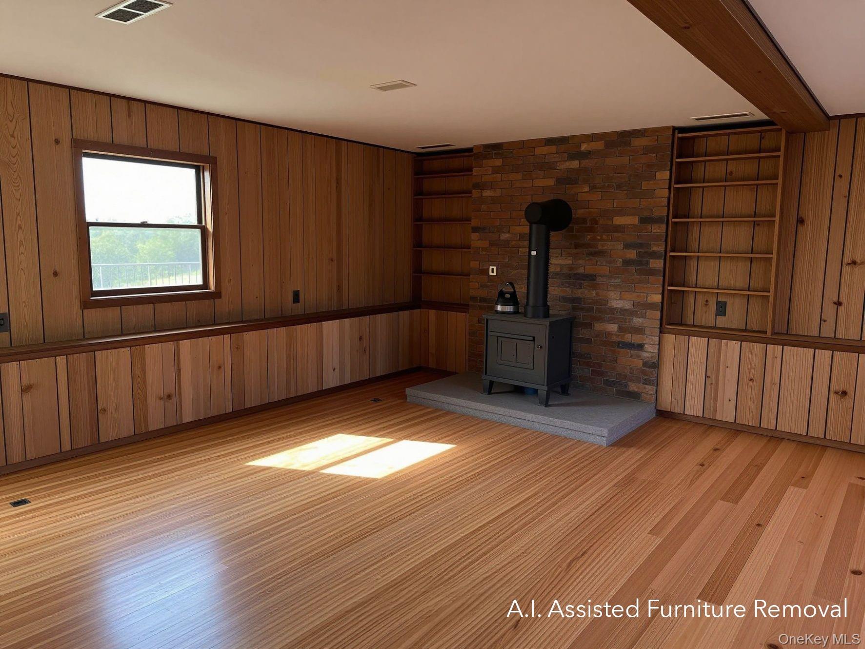 94 Booth Road Chester, NY 10918 - Photo 13 of 21 Spacious lower level room featuring wood-finish flooring, wood-paneled walls, and a brick accent wall with a built-in wood-burning stove on a raised hearth