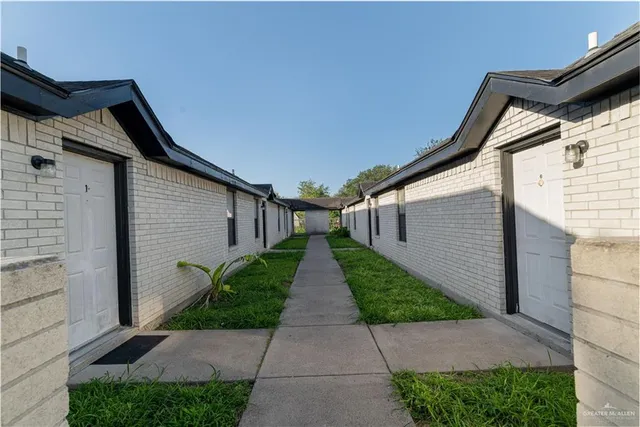 a view of a pathway with a house in the background