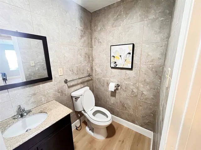 a bathroom with a toilet a sink and mirror