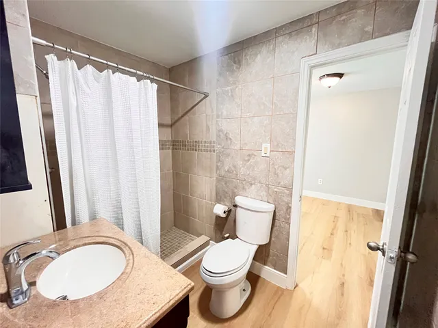 a bathroom with a toilet a sink and a mirror