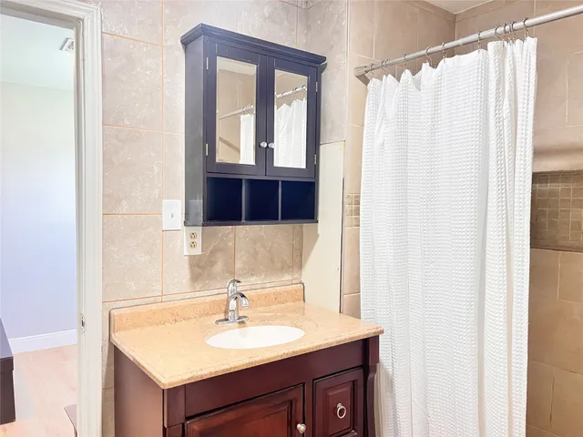 a bathroom with a sink vanity and a mirror