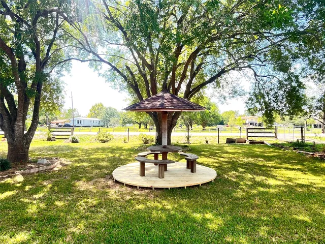 a view of a fountain in the yard with palm trees