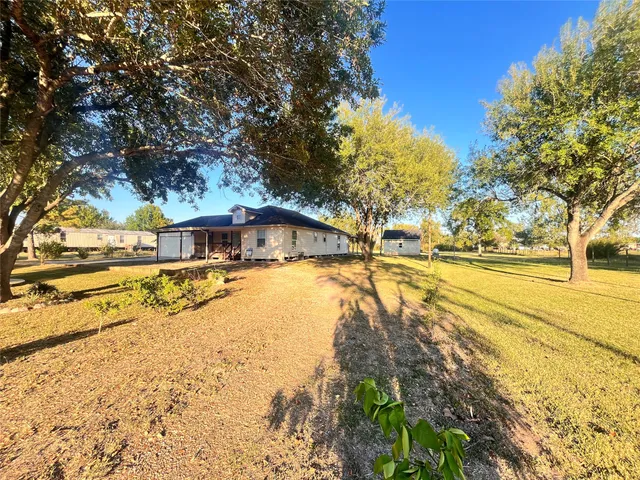 a swimming pool with trees in front of it