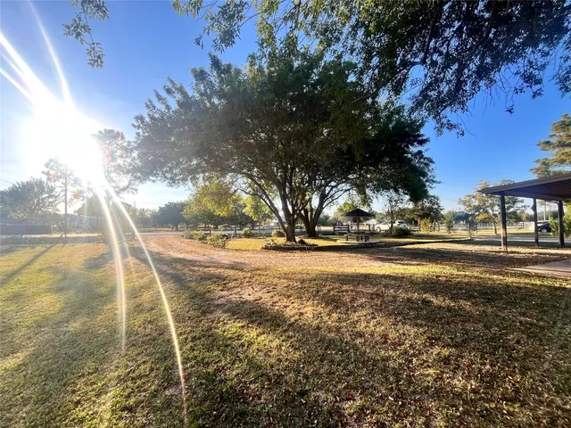 a view of yard with swimming pool and trees