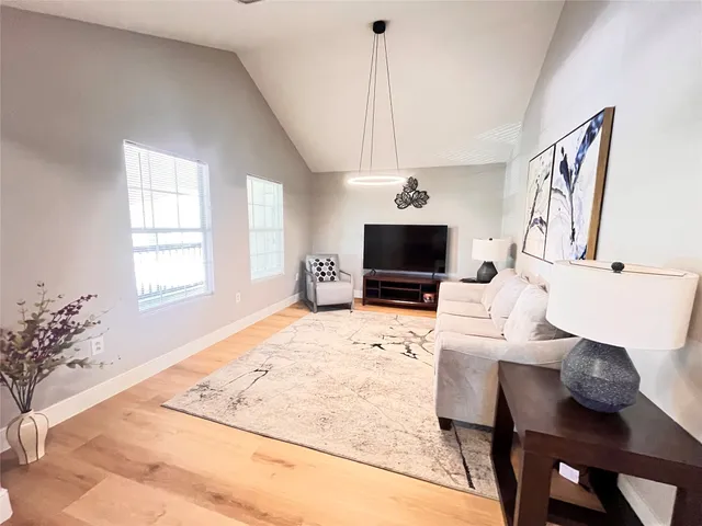 a view of a livingroom with furniture and a flat screen tv
