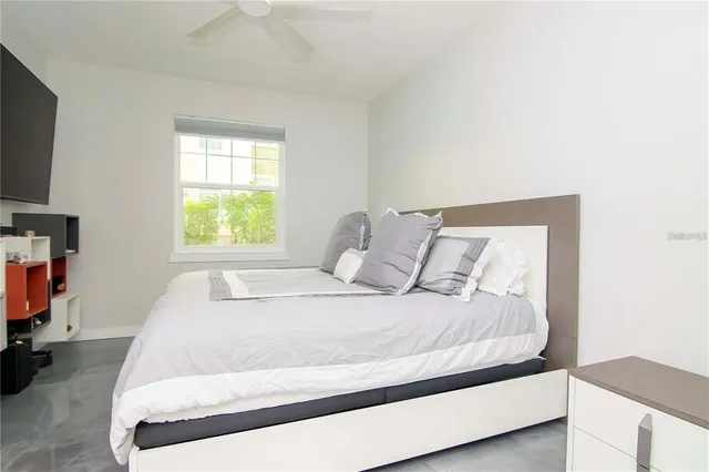 a large bed sitting in a bedroom next to a window