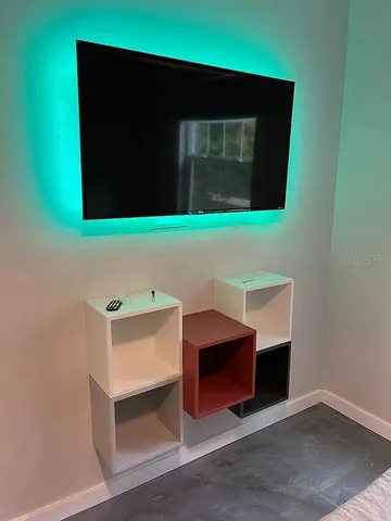 a room with wooden floor and furniture