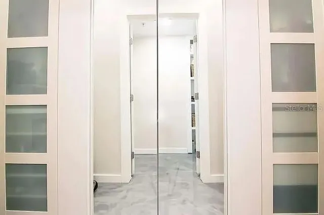 a view of a bathroom from a corridor