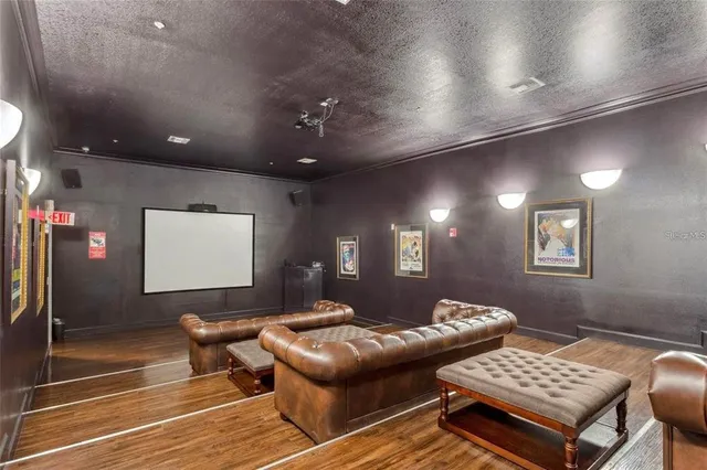 a view of a livingroom with furniture wooden floor and a fireplace