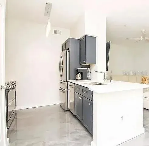 a kitchen with stainless steel appliances a sink stove and refrigerator