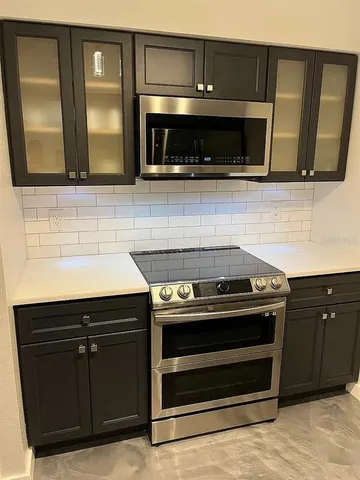 a stove top oven sitting inside of a kitchen