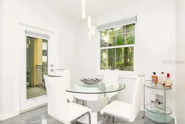 a dining room with furniture and window