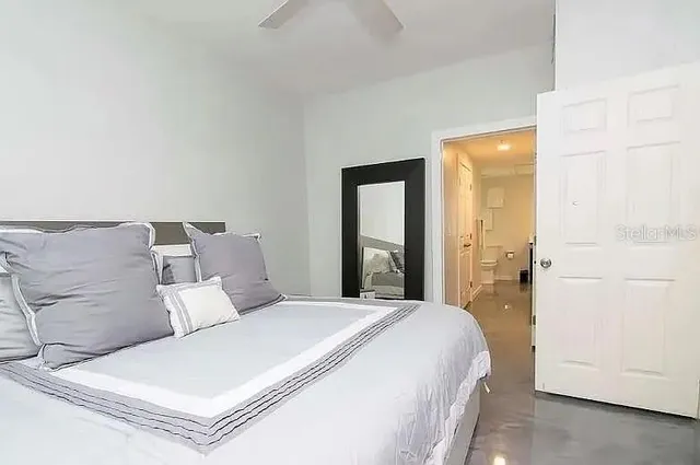 a large white bed in a white room