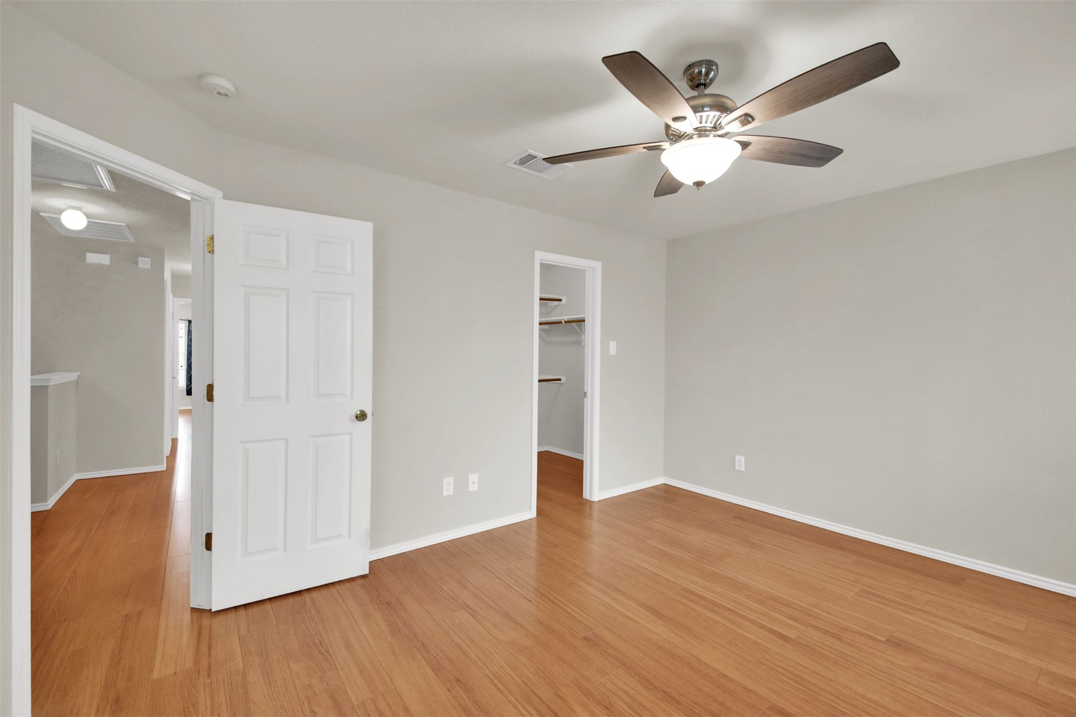 73 Verde Ranch Loop Leander, TX 78641 - Photo 19 of 29 Unfurnished bedroom featuring baseboards, visible vents, light wood-style flooring, and a spacious closet