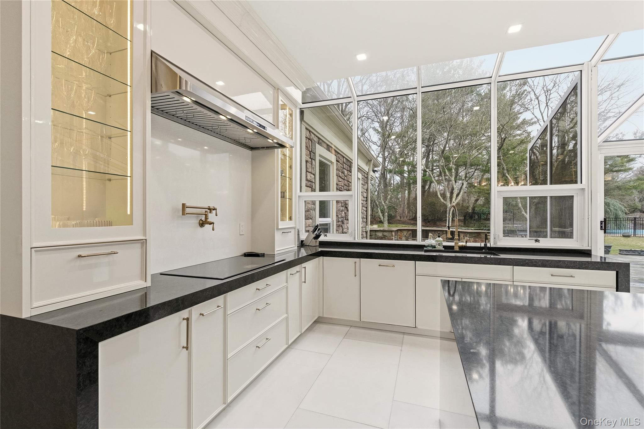 55 Coves Run Syosset, NY 11791 - Photo 16 of 50 a large kitchen with granite countertop a sink and a window
