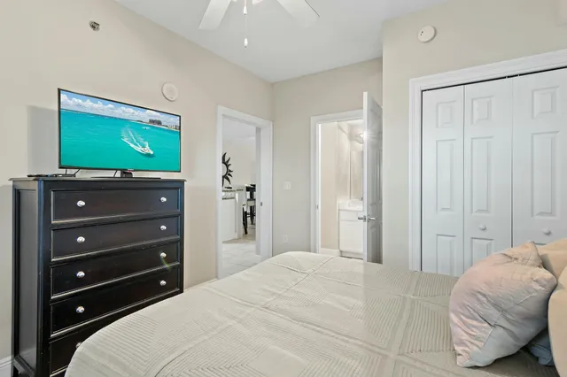 a bedroom with a bed and a flat screen tv