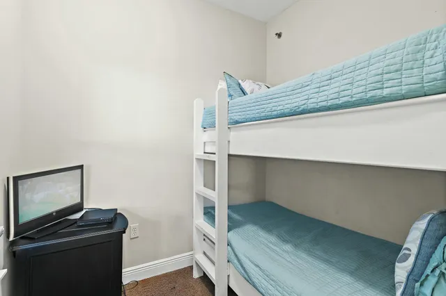 a kitchen with a sink a refrigerator and cabinets