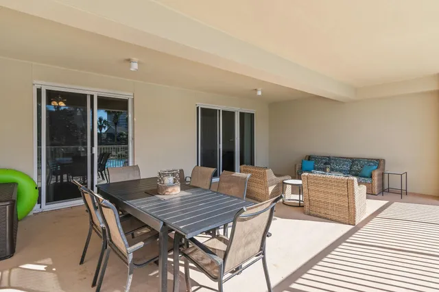 a view of a dining table and chairs on the roof deck