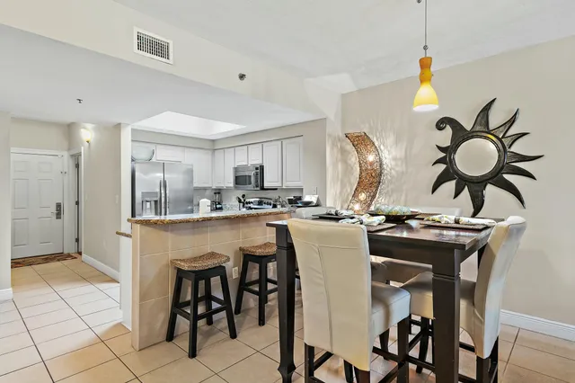 a kitchen with stainless steel appliances granite countertop a sink a stove and a refrigerator