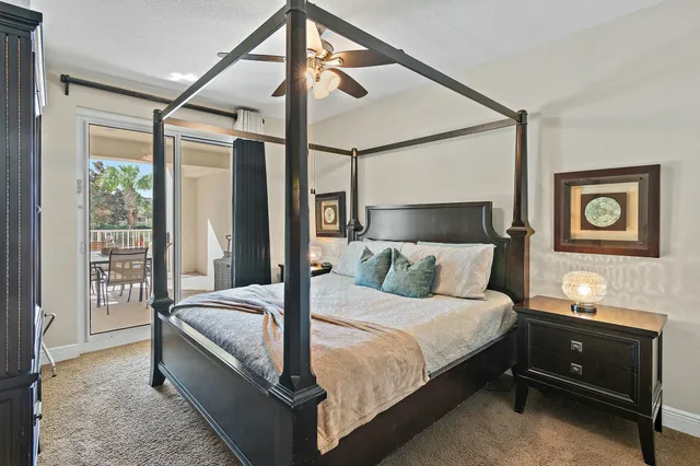 a bedroom with a bed and large window