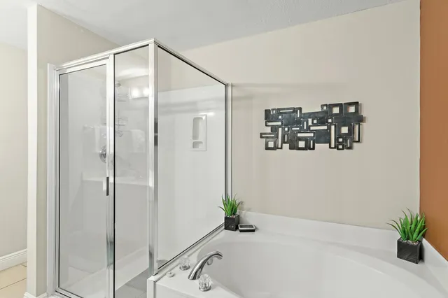 a bathroom with a bathtub and a shower