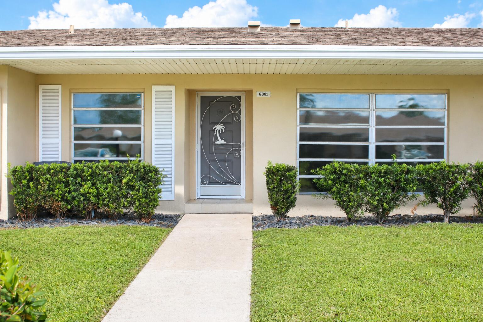 8861 Bella Vista Drive Boca Raton, FL 33433 - Photo 1 of 16 a view of house with garden and entertaining space