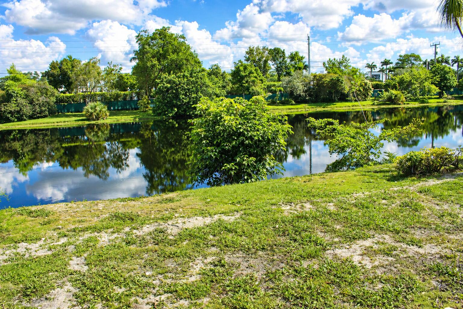 8861 Bella Vista Drive Boca Raton, FL 33433 - Photo 15 of 16 a view of a lake with a big yard