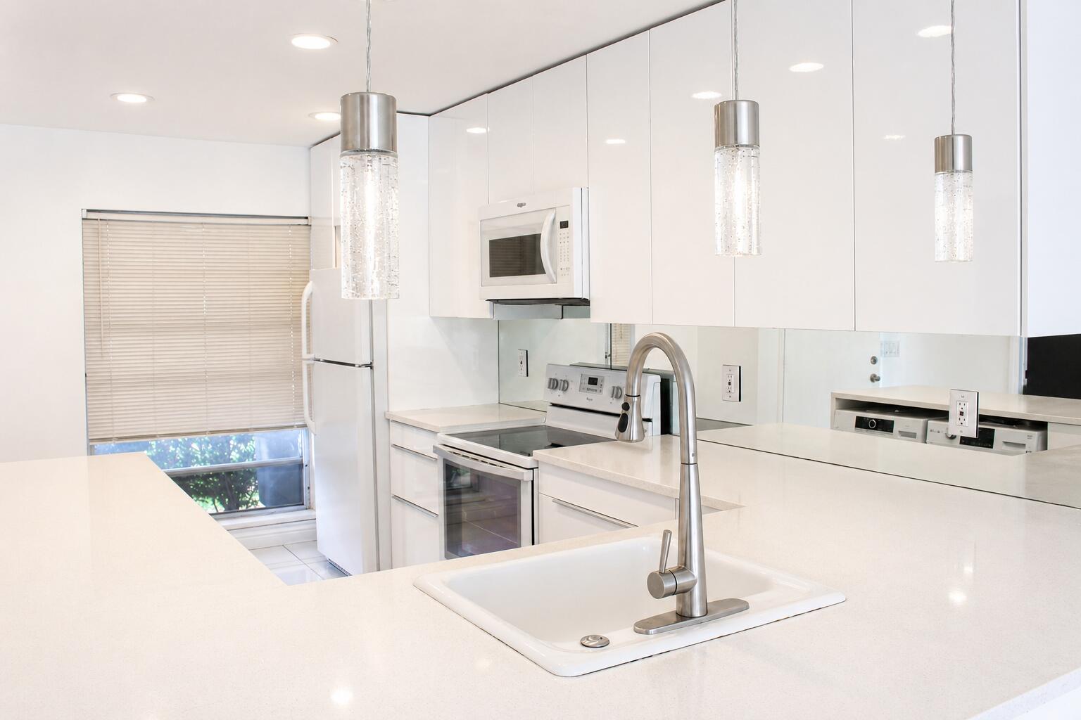 8861 Bella Vista Drive Boca Raton, FL 33433 - Photo 6 of 16 a kitchen with kitchen island a sink appliances and a counter top space