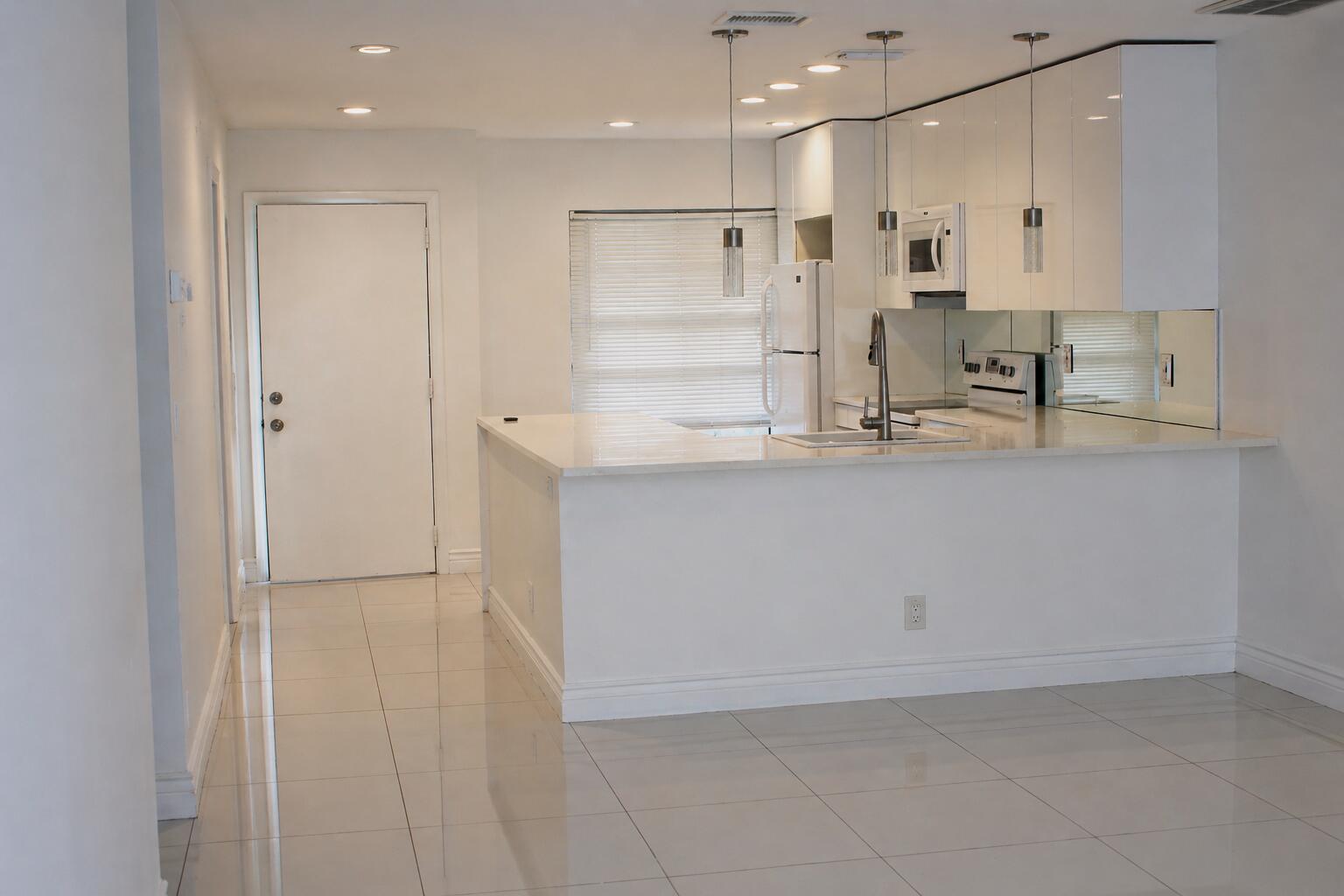 8861 Bella Vista Drive Boca Raton, FL 33433 - Photo 8 of 16 a view of kitchen with white cabinets