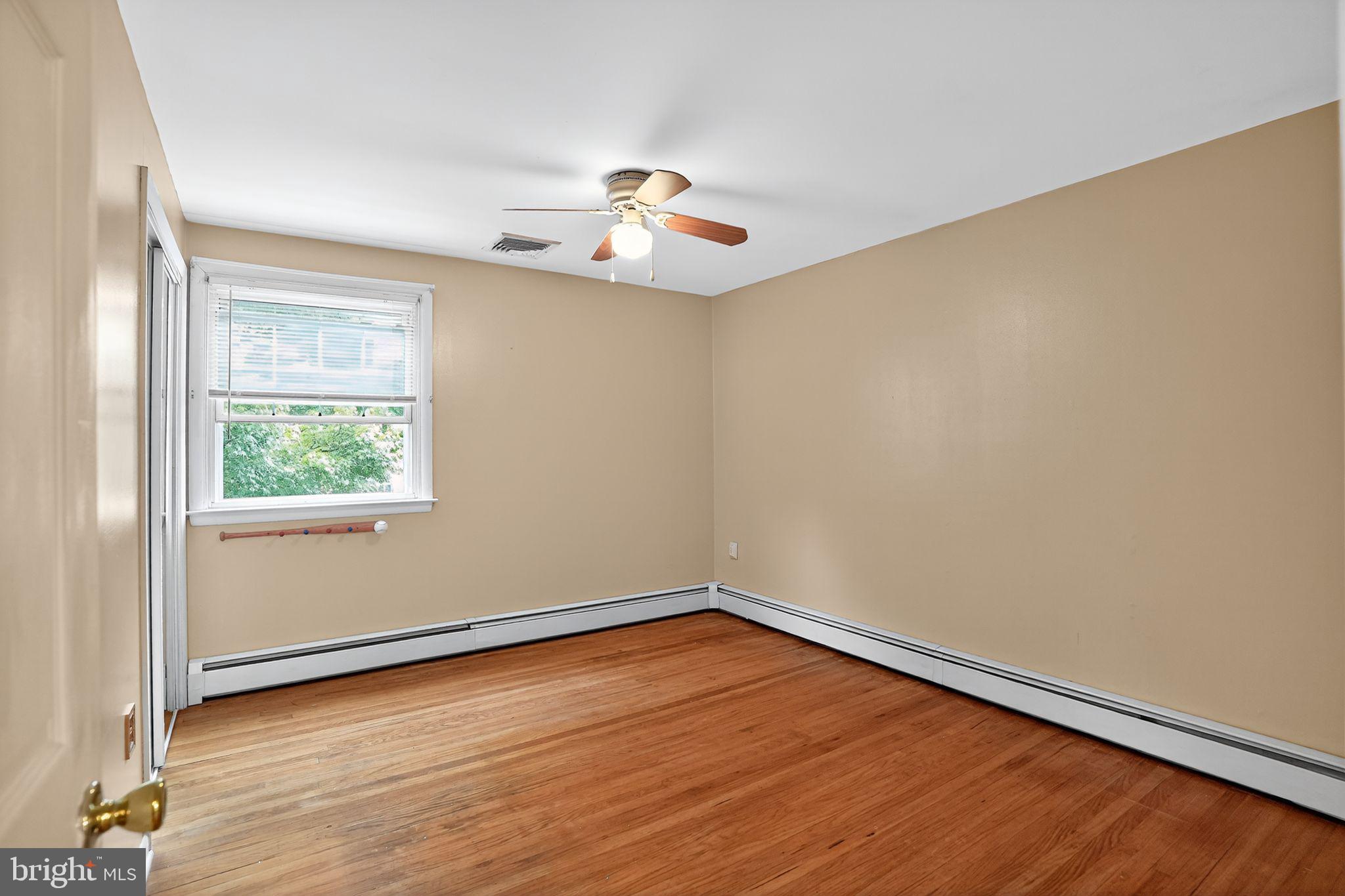 719 Pine Ridge Road Media, PA 19063 - Photo 16 of 29 an empty room with wooden floor and windows