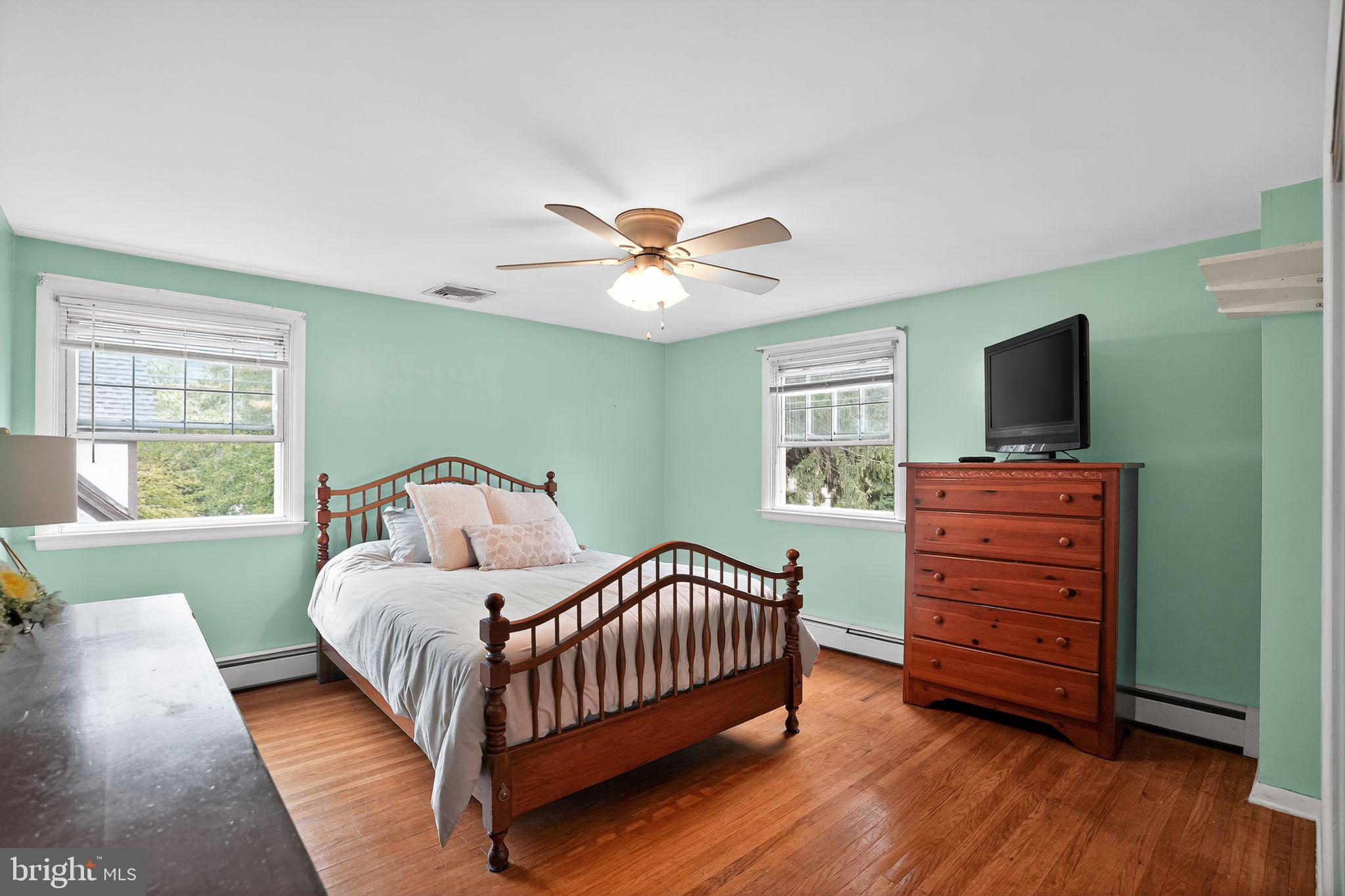 719 Pine Ridge Road Media, PA 19063 - Photo 18 of 29 a bedroom with a bed and a flat screen tv with wooden floor