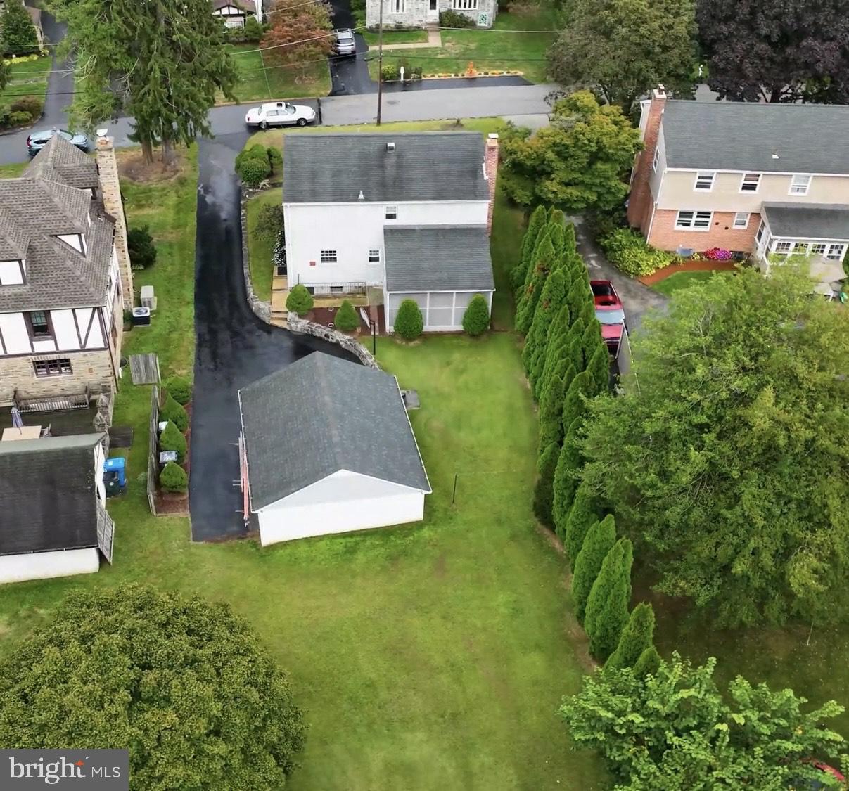 719 Pine Ridge Road Media, PA 19063 - Photo 2 of 29 an aerial view of a house with swimming pool and garden