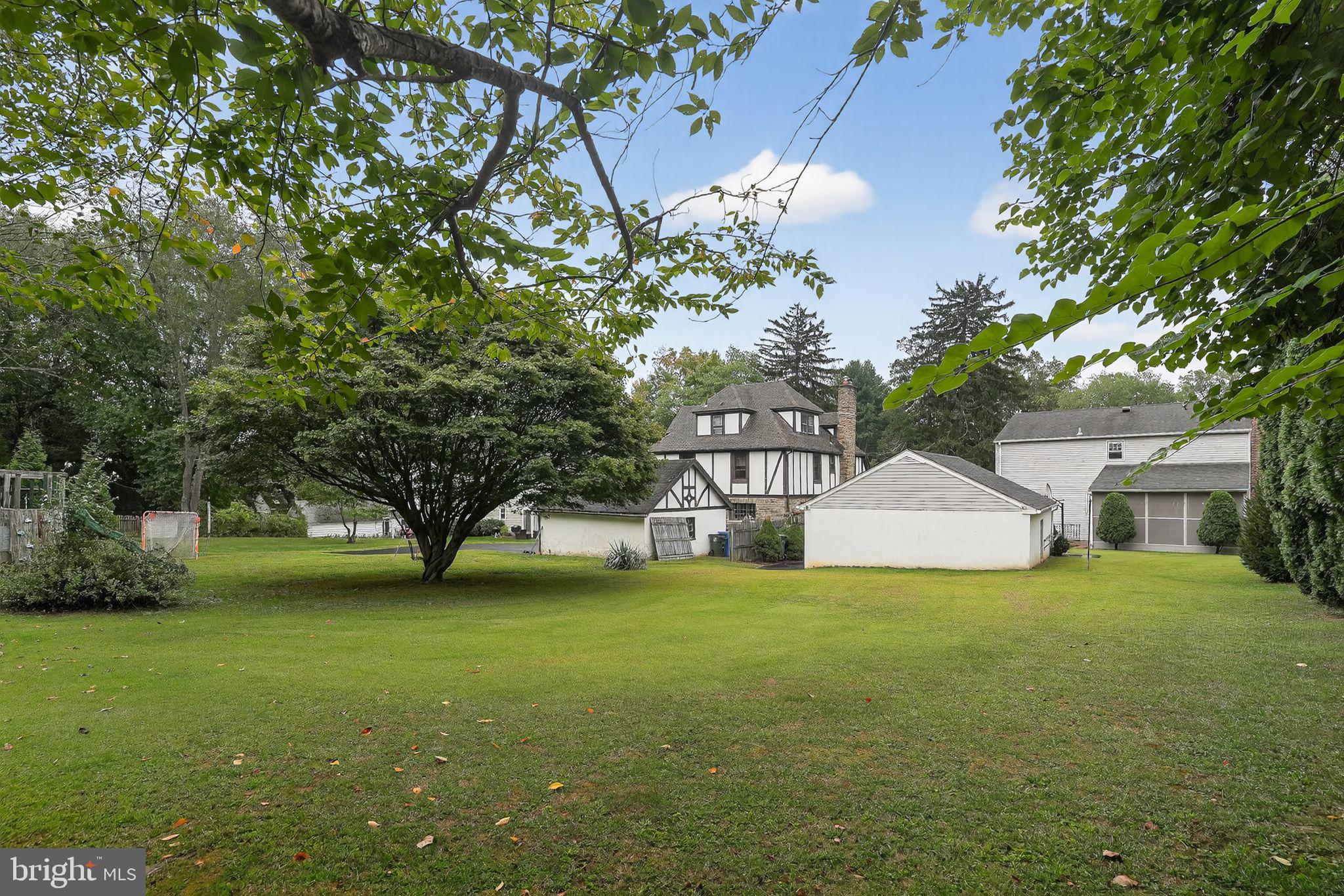 719 Pine Ridge Road Media, PA 19063 - Photo 24 of 29 a view of a house with a big yard and large trees