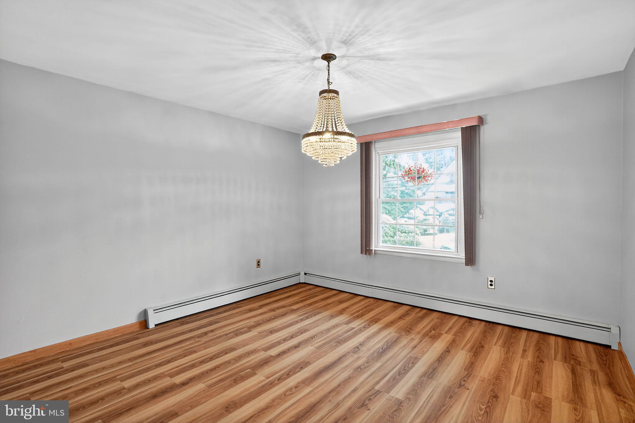 719 Pine Ridge Road Media, PA 19063 - Photo 6 of 29 a room with window and wooden floor
