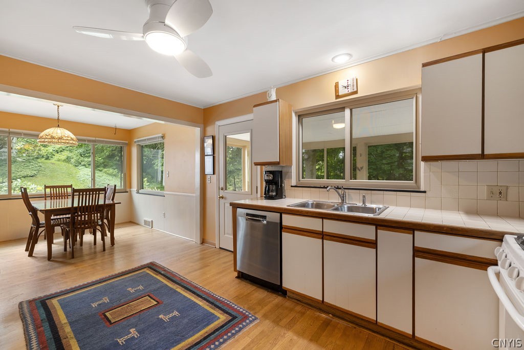 108 Archer Road Syracuse, NY 13207 - Photo 15 of 44 Kitchen and dining area flow to both screened porch and living room