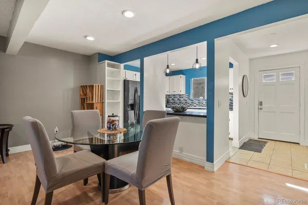 a living room with furniture a flat screen tv and kitchen view