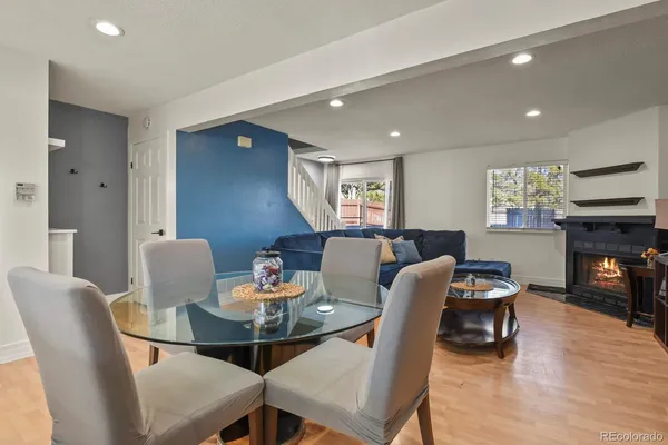 a living room with granite countertop furniture and a refrigerator