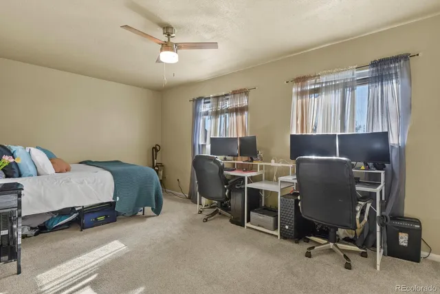 a bedroom with a bed a chair and piano