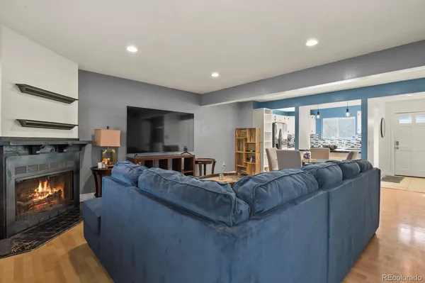 a living room with furniture and a wooden floor