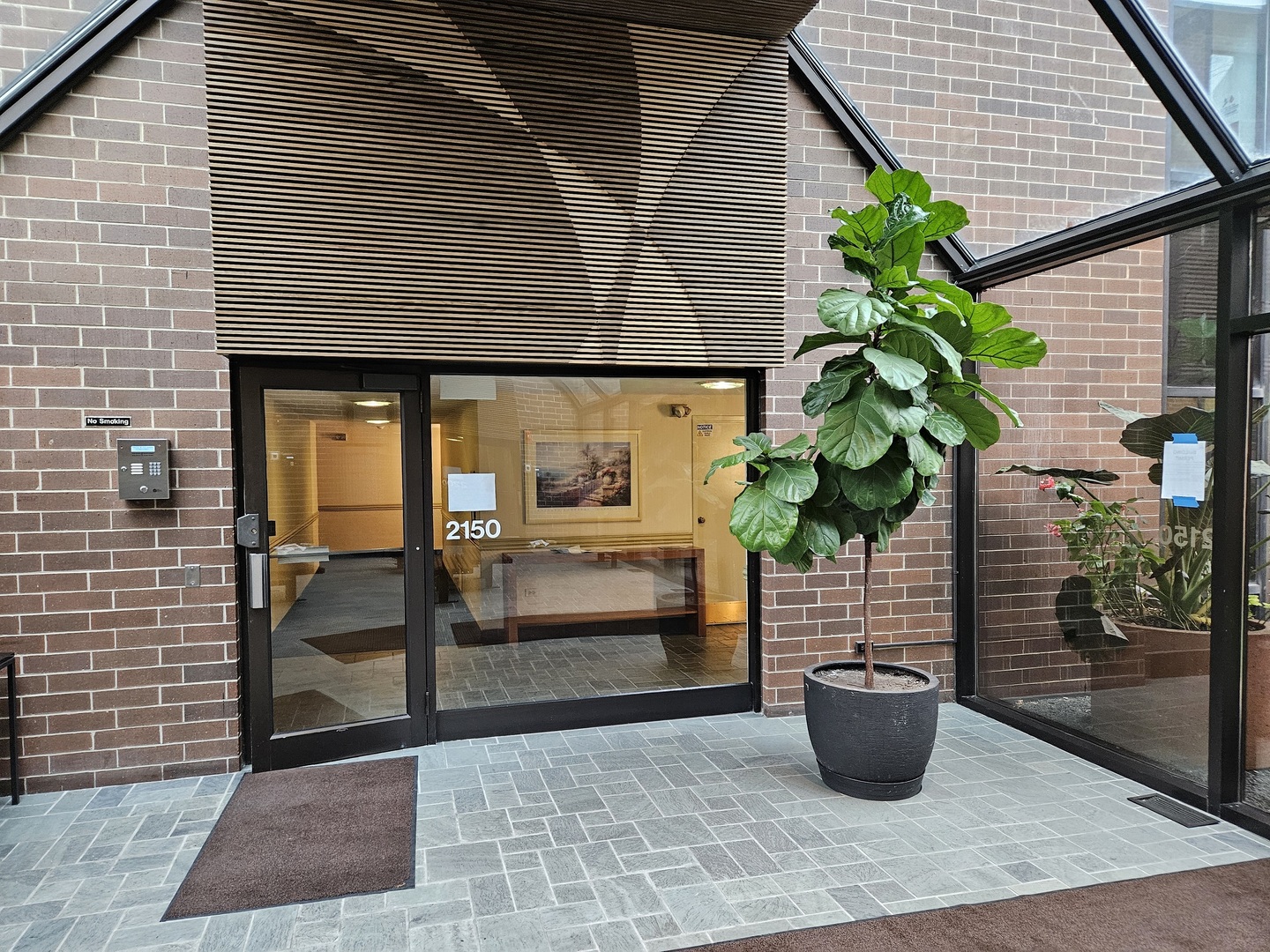 2150 Bouterse Street, Unit 106 Park Ridge, IL 60068 - Photo 1 of 25 a potted plant sitting in front of a house