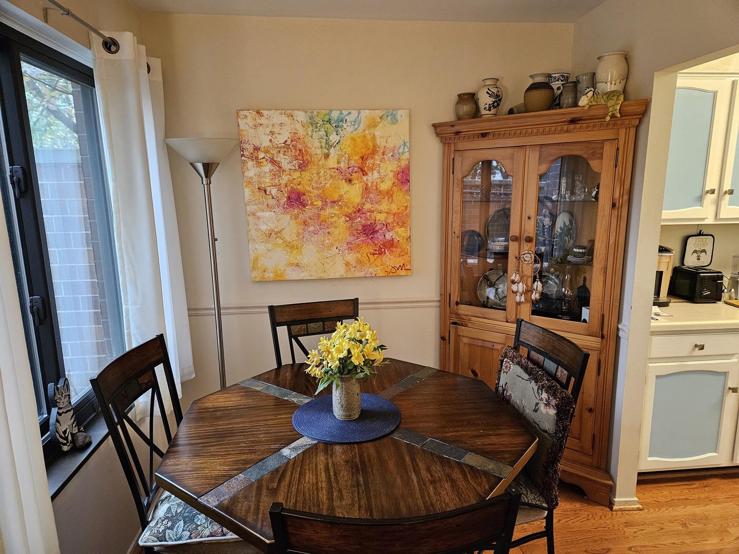 2150 Bouterse Street, Unit 106 Park Ridge, IL 60068 - Photo 7 of 25 a view of a dining room with furniture a rug and wooden floor