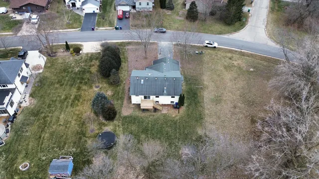 an aerial view of a house with a yard