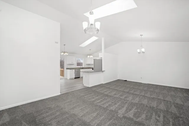 a view of a kitchen with wooden floor