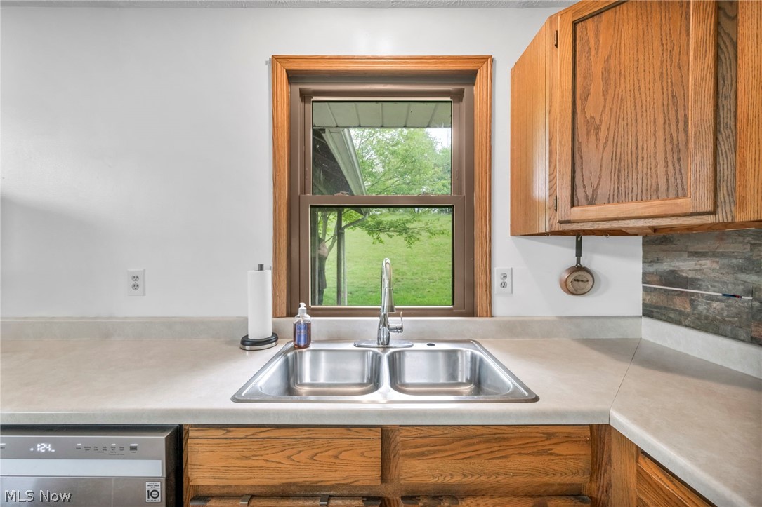 4560 Arrow Road Northwest Carrollton, OH 44615 - Photo 12 of 41 Kitchen with sink, tasteful backsplash, and dishwasher